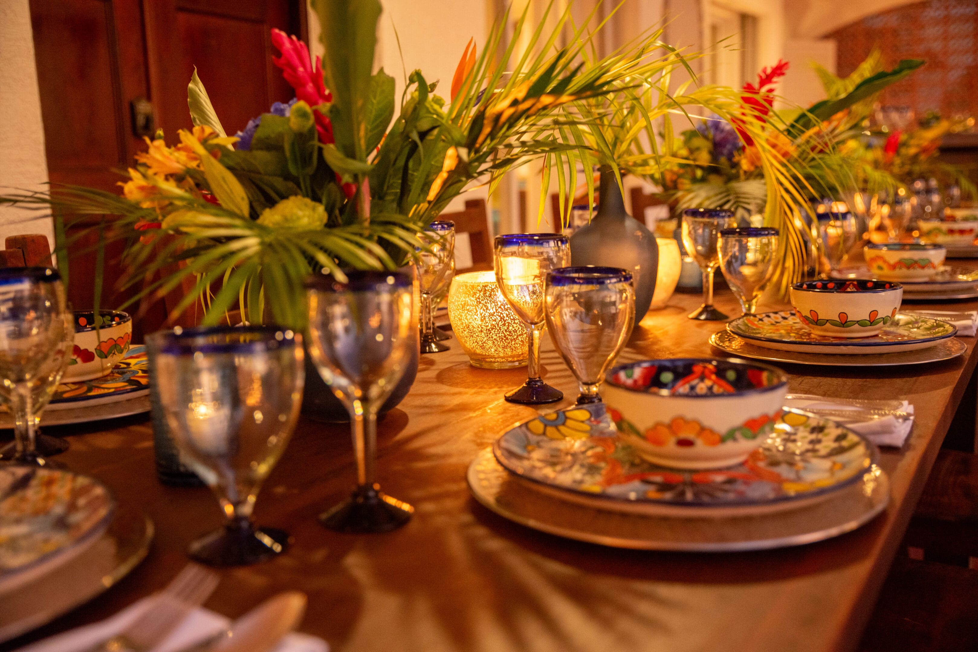 A table set with plates, cups and vases.