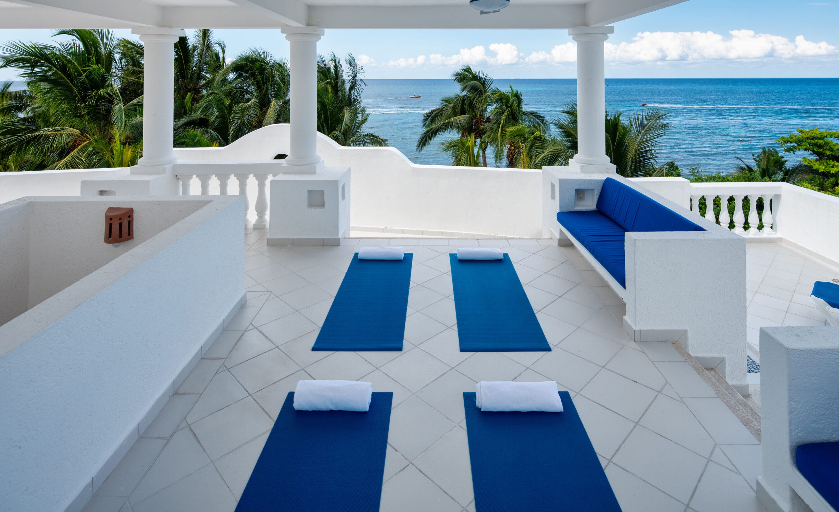 A white room with four blue mats on the floor